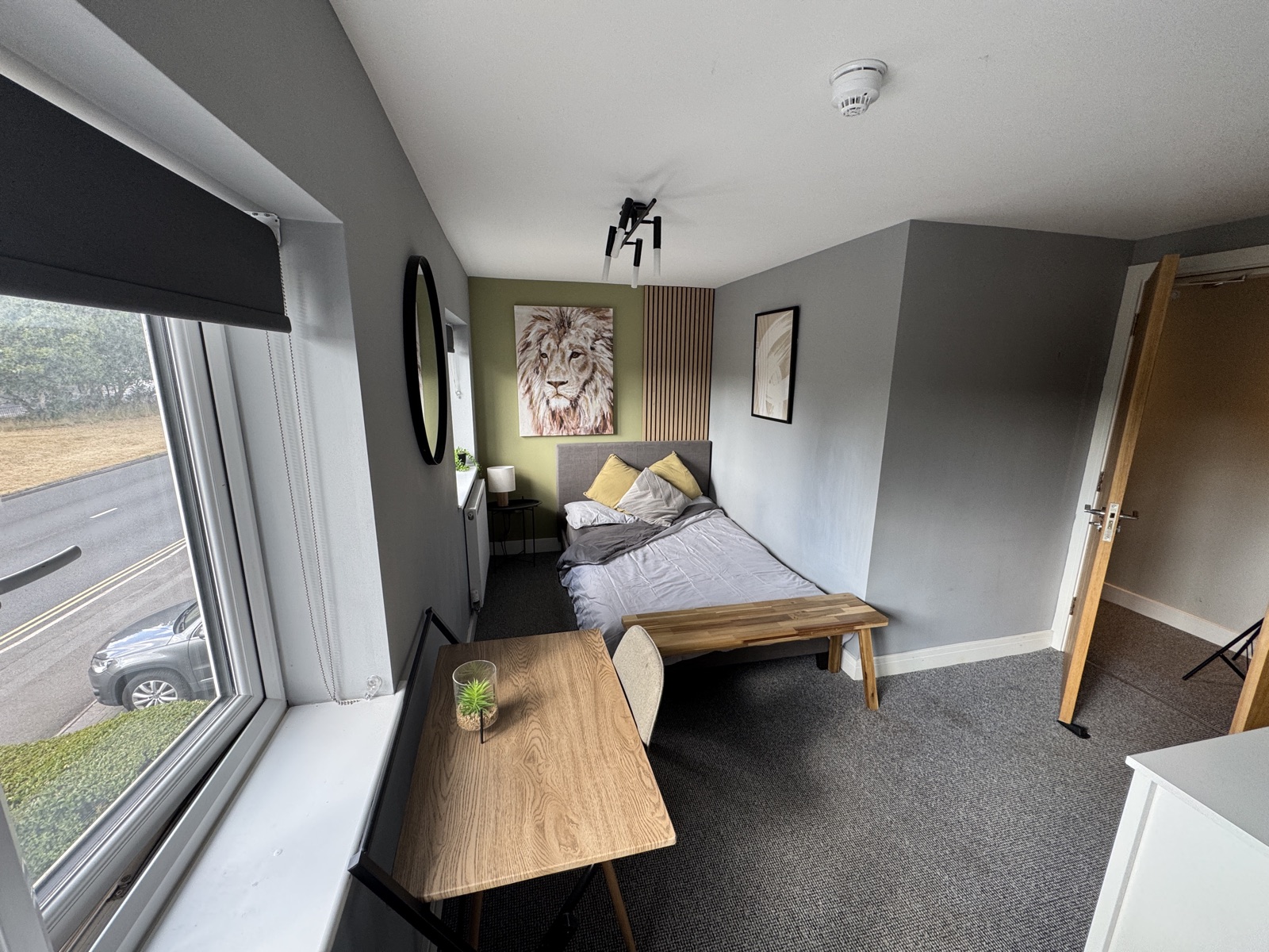 Bedroom with lion artwork, desk and slatted feature wall